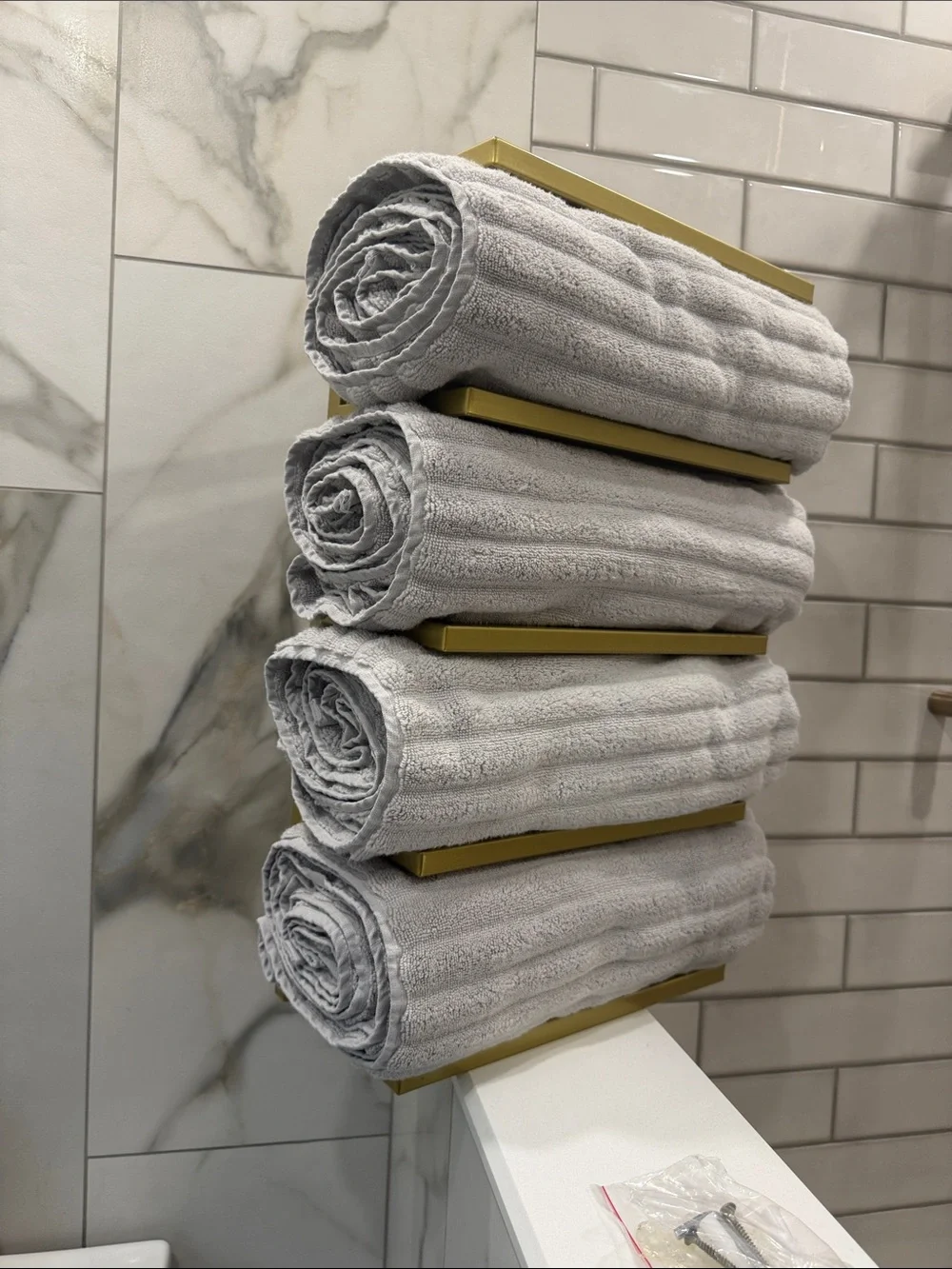 Gold Wall-Mounted Towel Rack with Green and Beige Towels - Modern Bath Storage